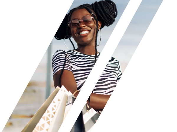 A smiling woman in the middle of shopping.